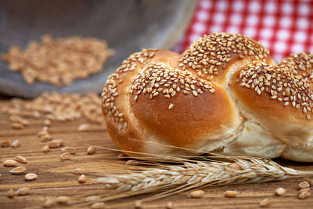 Crunchy fresh bun isolated on the old wooden tableの写真素材