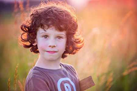 Summer warrior - playing on the filed in sunsetの写真素材