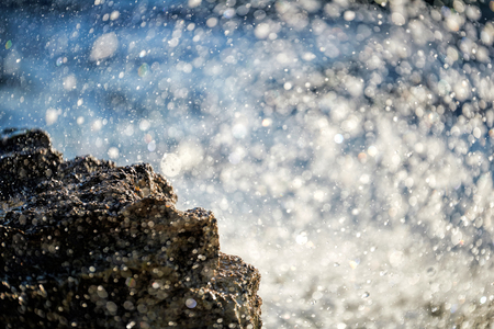 Water splashing - crystal clear sea water beating against the rocks and cliffs.の写真素材