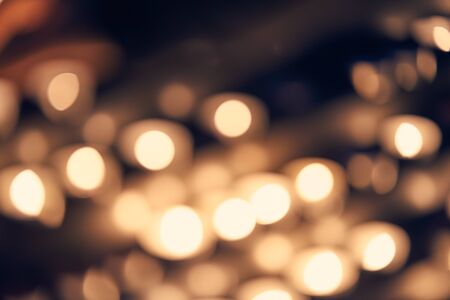Blurred abstract background of candle lights, bokeh in cool vintage color toneの写真素材