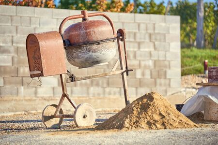 Cement mixer, sand and tools  Cement / concrete mixer at a construction siteの写真素材