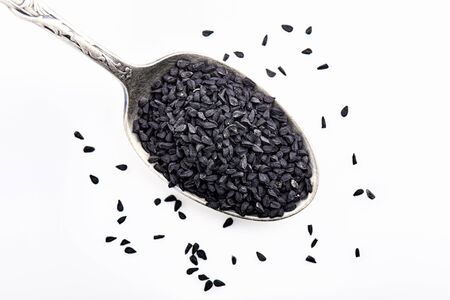 Nigella seed close up, isolated on white backgroundの写真素材