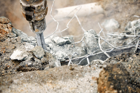 Close up of jackhammer - worker man using a jackhammer to drill into concreteの写真素材