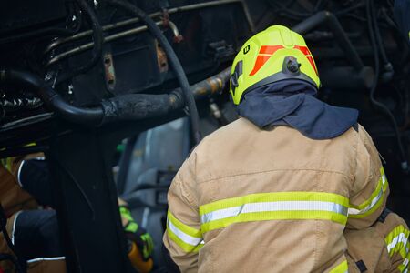Firefighter in action at a heavy car accident scene