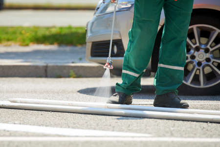 Road marking - Crosswalk painting, white painting on asphalt roadの写真素材