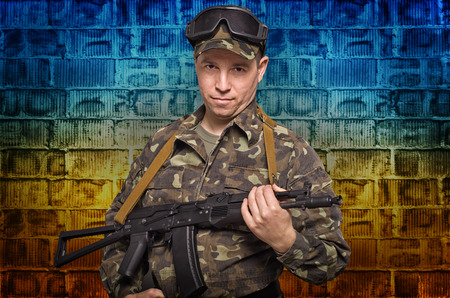Soldier on background brick wall yellow blue color