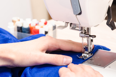 Female hands are busy by sewingの写真素材