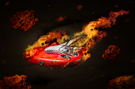 Burning guitar flying in space among meteoritesの写真素材