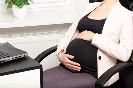 Pregnant woman in the workplaceの写真素材