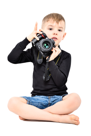 Attractive boy photographer, sitting isolated on white backgroundの写真素材