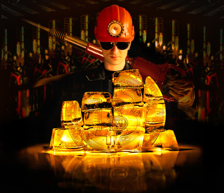 Miner, standing behind Bitcoin in the form of a coin, collected from gold blocksの写真素材