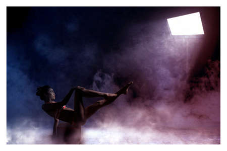 beautiful young and sexy Girl pose in studio dark background with smoke and lightsの写真素材