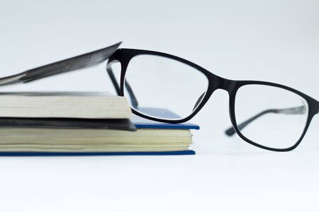 glasses and book isolated on white background.の写真素材