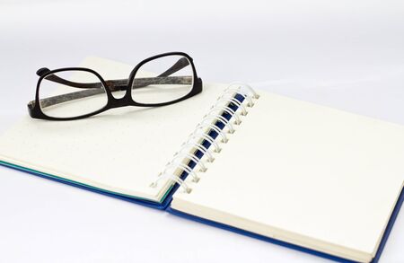glasses and book isolated on white background.の写真素材