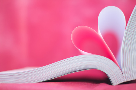 pages of a book curved into a heart shapeの写真素材