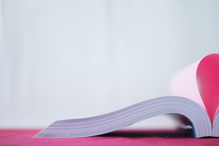 pages of a book curved into a heart shapeの写真素材