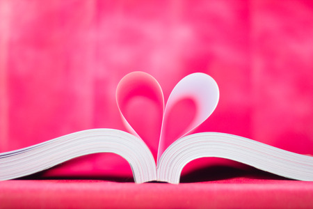 pages of a book curved into a heart shapeの写真素材