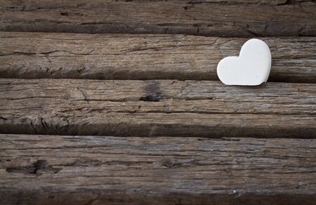white heart on wood background. Idea of valentine concept.の写真素材