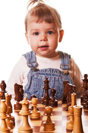 Portrait of  girl behind chess desk, isolated on white background.の写真素材