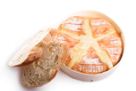 Backed camembert cheese with french baguette. Object isolated on white background.の写真素材