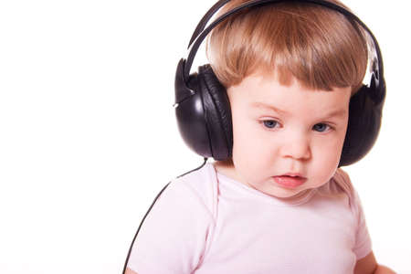  girl listening musing with headphones. Isolated on white background.の写真素材