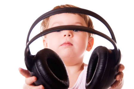 Child holding out the headphones. Isolated on white background.の写真素材