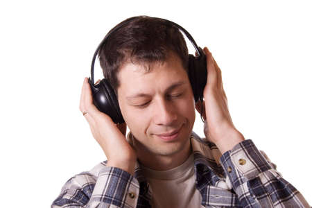Young mean in headphones with closed eyes listening to the music. Studio shot, isolated on white background.の写真素材