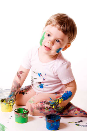 Little girl painting with hands. Isolated on white.の写真素材