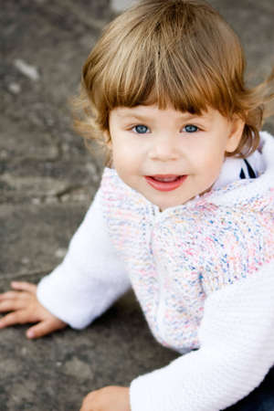 Portrait of 2 years old girl in casual white cardigan.の写真素材