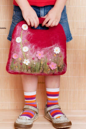 Handmade felt bag in the girls hands.の写真素材