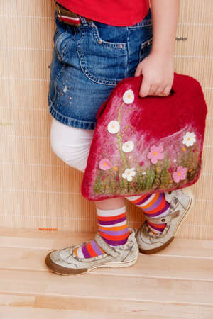 Handmade felt bag in the girls hands.の写真素材