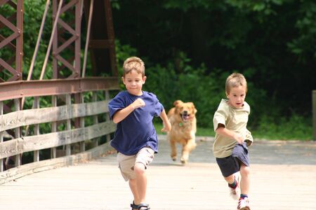 Boys Running with Dogの写真素材