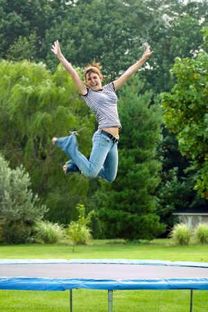 Girl Jumping on Trampolineの写真素材