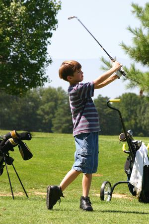 Boy golfingの写真素材