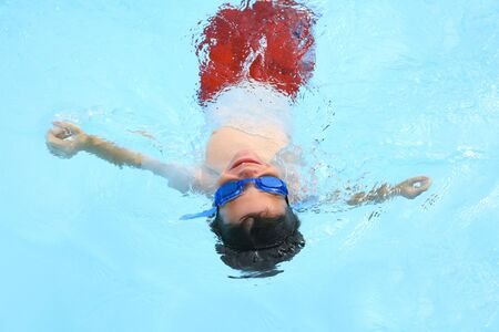 Boy Floating in Poolの写真素材