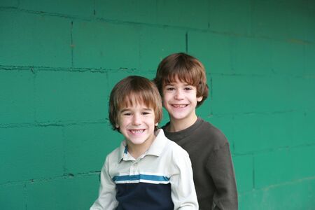 Two Boys Against a Green Backgroundの写真素材