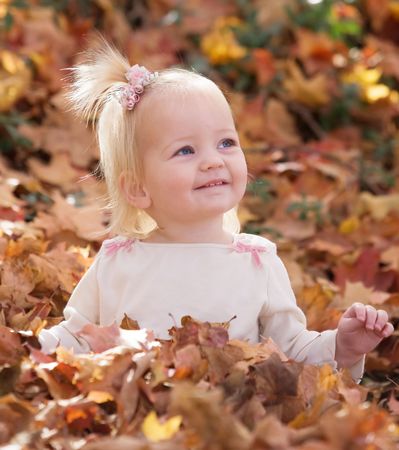 Girl Playing in Fall Leavesの写真素材