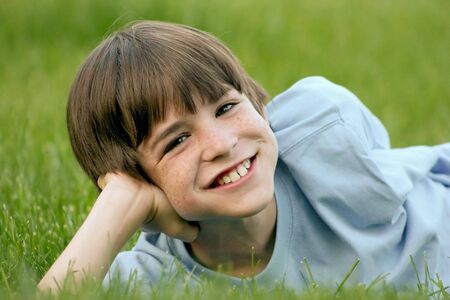 Boy Laying in Grassの写真素材