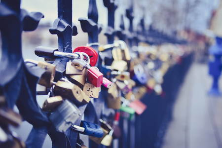 Locks of lovers on the wrought fence on Staromestska side of Vltava near the Charles bridge in Prague, Czech Republic. Selective focusの写真素材
