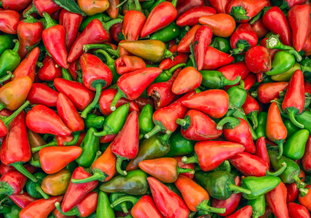Small green and red paprika on a market stall in Viennaの写真素材