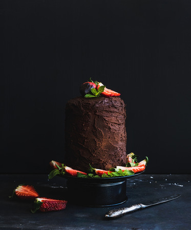 Rustic chocolate high cake with strawberry, dark background, selective focusの写真素材