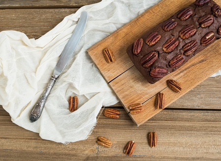 Pecan brownie cake on a wooden board