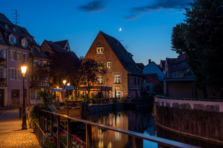 Traditional french houses on the side of chanel Petite Venise, Colmar, France, at nightの写真素材