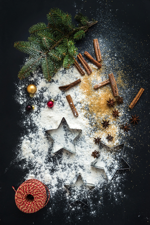 Baking ingredients for Christmas holiday traditional gingerbread cookies preparation, black background, top viewの写真素材