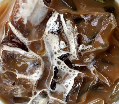 Closeup of iced coffee with milk and caramel , top view. Background, texture and wallpaperの写真素材