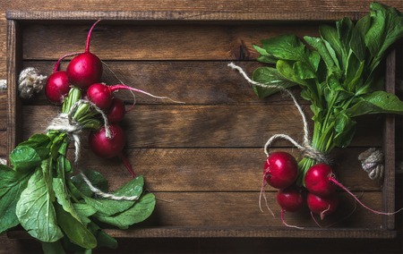 Fresh radish banches on wooden tray background. Top view, copy space, horizontal compositionの写真素材