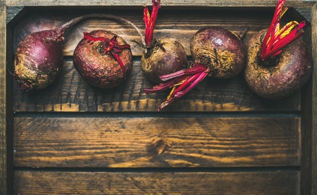 Raw organic purple beetroots in rustic wooden box, selective fovus, top view, copy spaceの写真素材