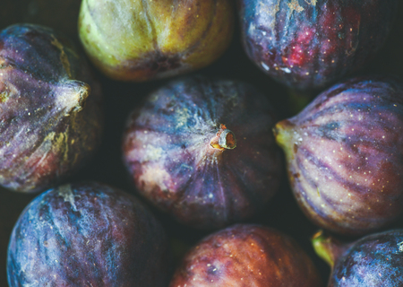 Close-up of fresh ripe purple figs, top view. Food texture and background. Organic fruit, local produce, farming, healthy food conceptsの写真素材