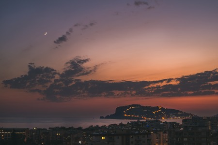 View from balcony of twilight over Mediterranean sea and Peninsula in evening lights, Alanya, Turkeyの写真素材