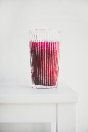 Fresh morning beetroot smoothie or juice in glass, white background, copy space. Healthy vegan or vegetarian breakfast, seasonal detox, clean eating, alcaline diet, weight loss food conceptの写真素材
